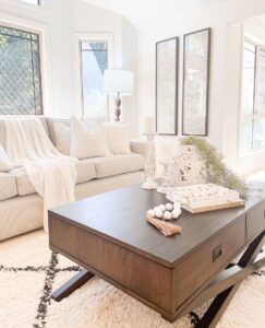 A side view of a dark polished wooden table and beige sofa, styled by the property staging experts at Sell in Style, Brisbane.
