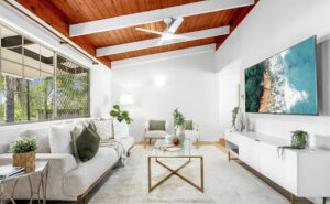 An exceptional living room featuring an ultra TV screen and a stunning entertainment table. Styled and staged by Sell in Style, Brisbane.